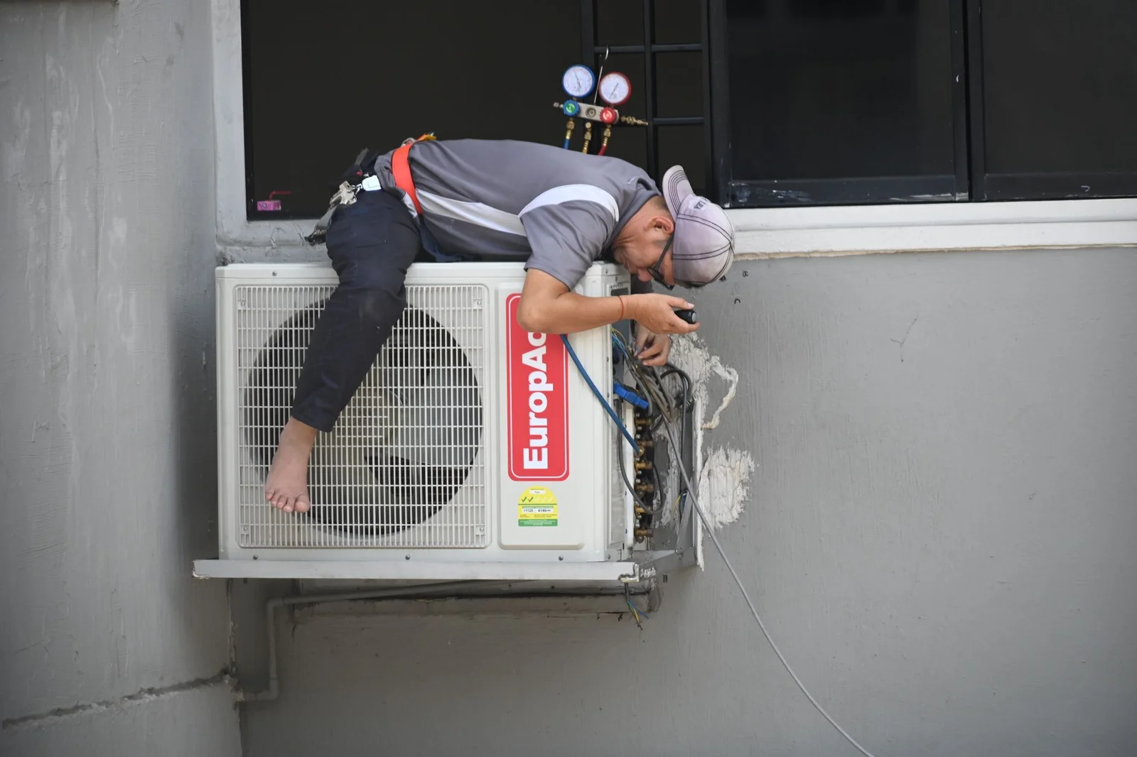 Technician measuring a home for a load calculation